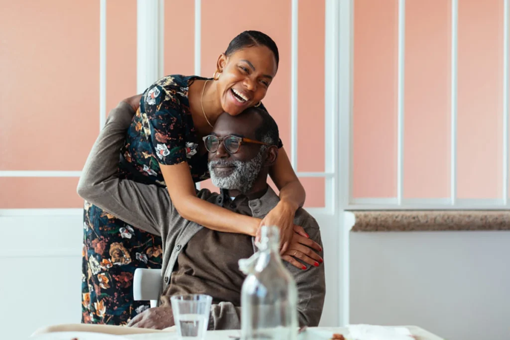 Smiling woman motivating a senior to participate in activities.