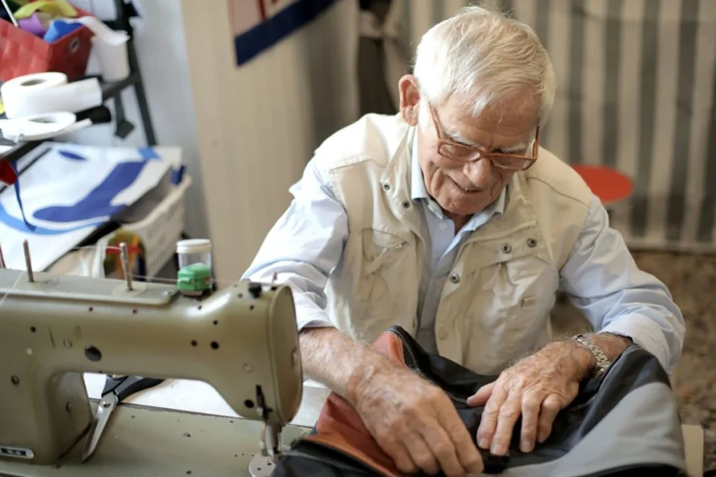 Senior participating in a sewing activity.