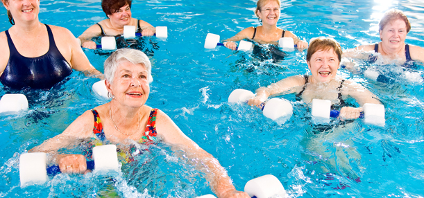 Elderly women having fun doing water aerobics.