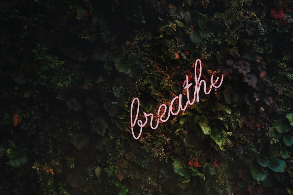 Neon "breathe" to represent the importance of wellness programs.