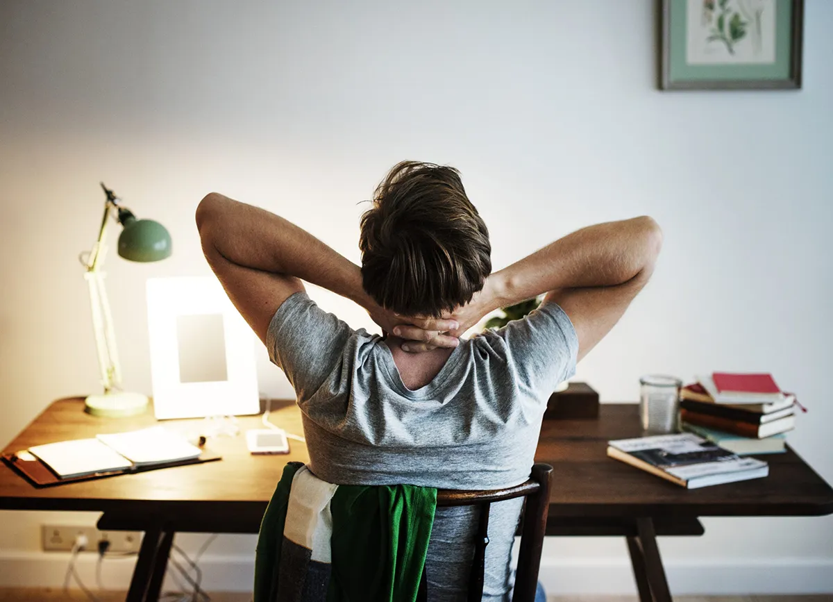 Man stressed out while working at his desk at home.