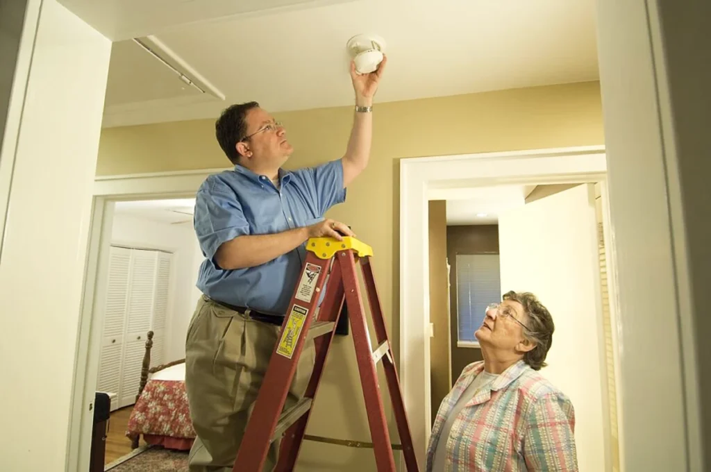 Smoke detector battery replacement, part of a home safety assessment checklist.