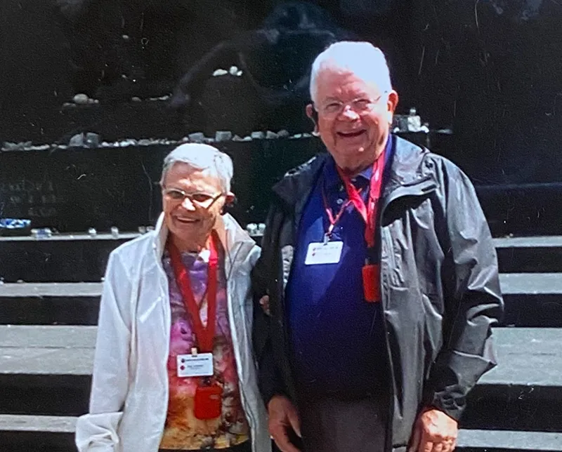 Joan and Dale standing outside.