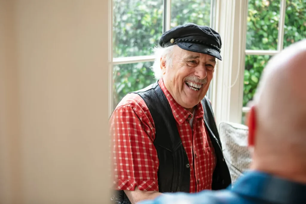 Elderly man discussing ageism in healthcare with another person.