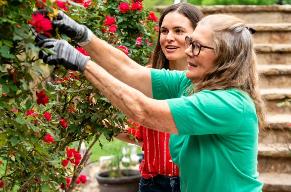 Two women participating in a community gardening activity.