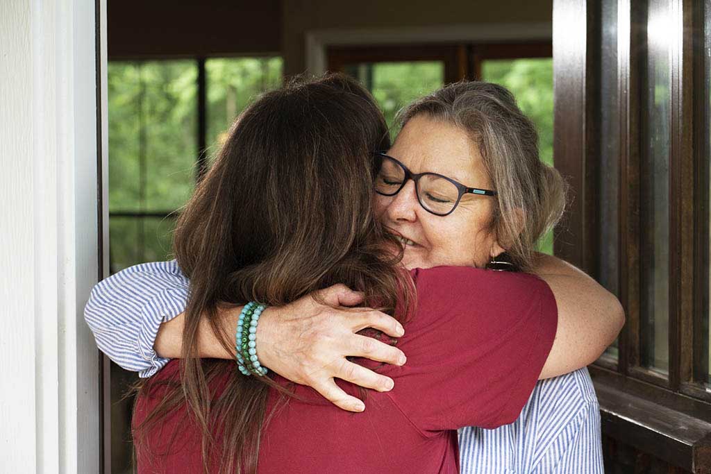 Two women hugging.