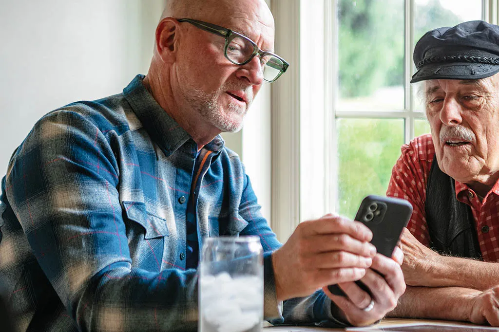 Papa Pal showing Papa member how to use the Papa app.