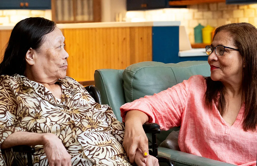 Two women looking at each other.